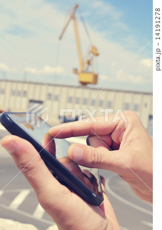 man using a tablet in an industrial park man using a tablet in an industrial park 14191278