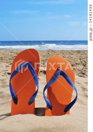 flip-flops on the sand of a beach 14191439