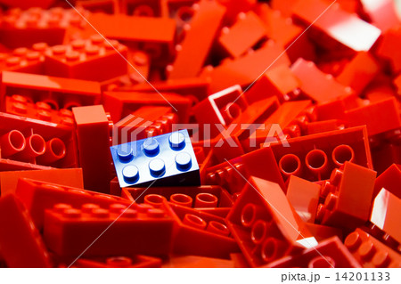 Pile of red color building blocks with selective focus and highlight on one blue block 14201133