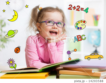 Funny smart kid in glasses reading book in kindergarten Funny smart kid in glasses reading book in kindergarten 14203588