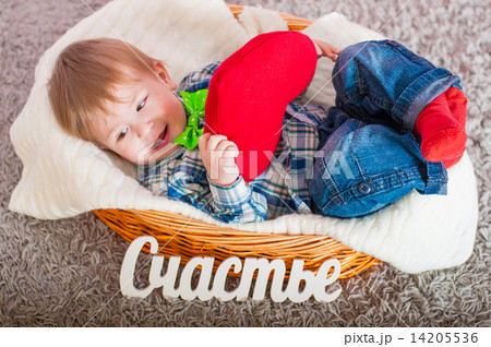 Child in the bow tie is in the basket with a blanket 14205536