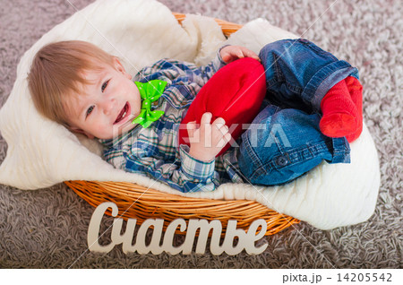 Child in the bow tie is in the basket with a blanket 14205542