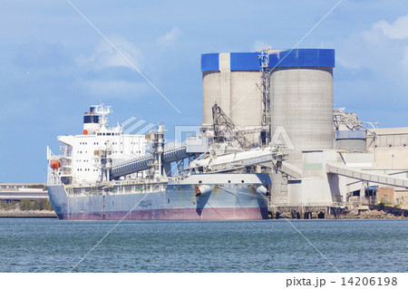Cargo ship unloading at a cement plant 14206198