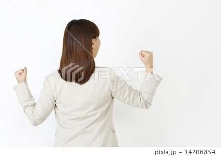 ガッツポーズする女性の後ろ姿の写真素材