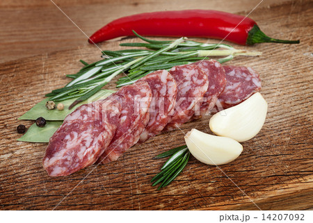 Sliced sausage spices and garlic on a board. Sliced sausage spices and garlic on a board. 14207092