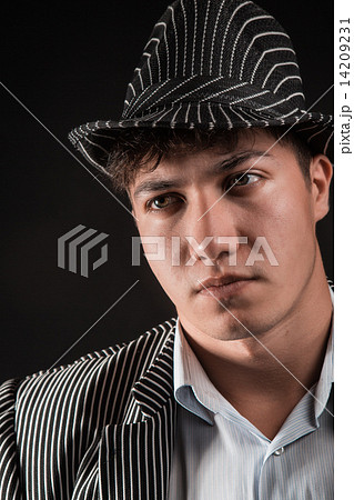 a man in a grey hat on black background 14209231