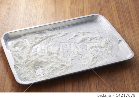 Flour in metal tray on wooden table 14217679