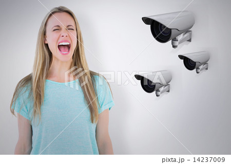 Composite image of furious blonde standing and screaming 14237009