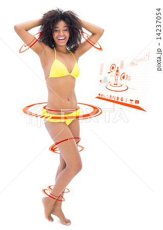Composite image of fit girl in yellow bikini smiling at camera 14237054