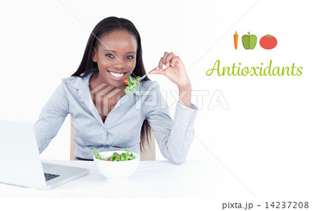 Antioxidants against cute businesswoman working with a notebook 14237208