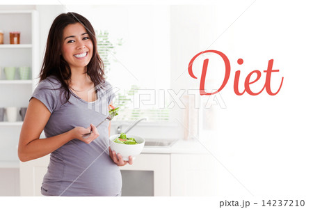Diet against attractive pregnant woman holding a bowl of salad w 14237210
