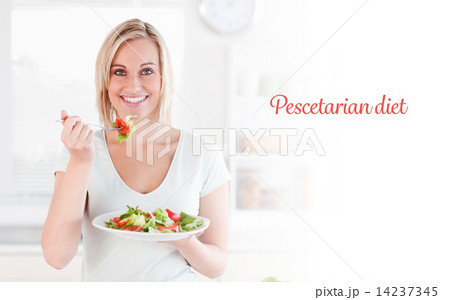 Pescetarian diet against close up of a gorgeous woman eating sal 14237345