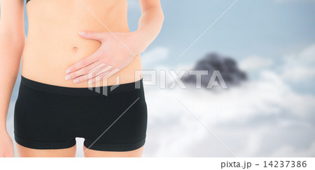 Composite image of closeup mid section of a fit woman with stoma Composite image of closeup mid section of a fit woman with stoma 14237386