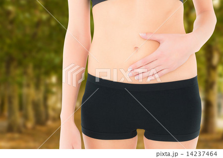 Composite image of closeup mid section of a fit woman with stoma Composite image of closeup mid section of a fit woman with stoma 14237464