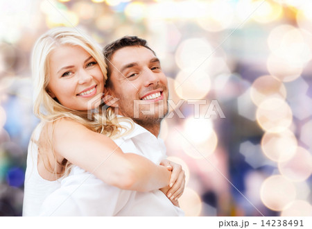 happy couple having fun over lights background happy couple having fun over lights background 14238491