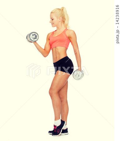 smiling sporty woman with heavy steel dumbbells smiling sporty woman with heavy steel dumbbells 14238916