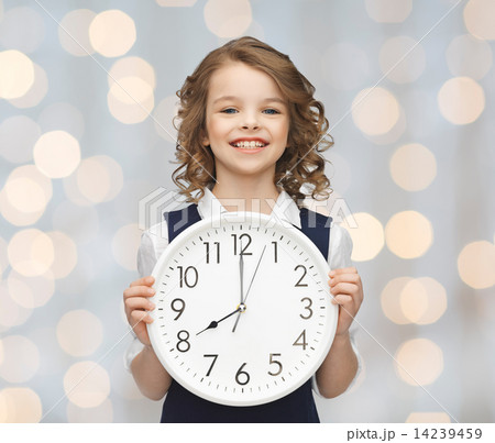 smiling girl holding big clock 14239459