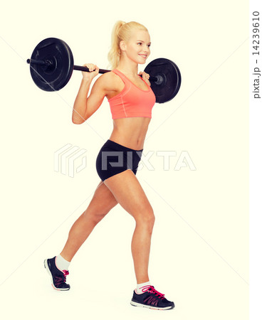 smiling sporty woman exercising with barbell 14239610