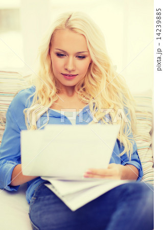 smiling young woman with papers at home 14239885