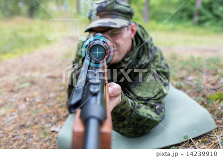 close up of soldier or sniper with gun in forest 14239910