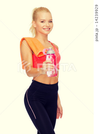 smiling sporty woman with water bottle and towel smiling sporty woman with water bottle and towel 14239929
