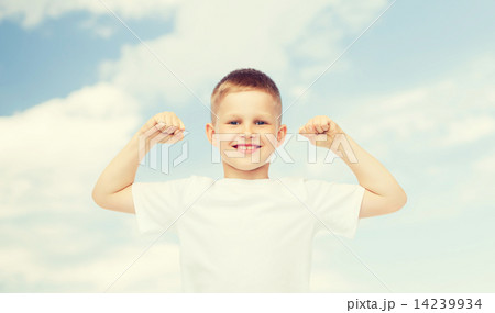 happy little boy in white t-shirt flexing biceps happy little boy in white t-shirt flexing biceps 14239934