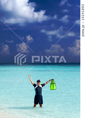 man in the sea with the equipment for a snorkeling man in the sea with the equipment for a snorkeling 14241893