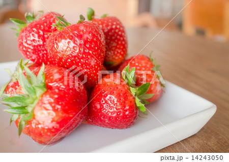 Fresh ripe strawberries on white plate 14243050