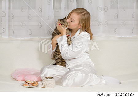 Young woman in pajamas with a cat Young woman in pajamas with a cat 14243437