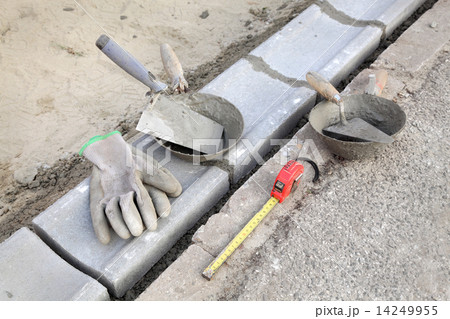 Construction site, curb stone and mason tools 14249955
