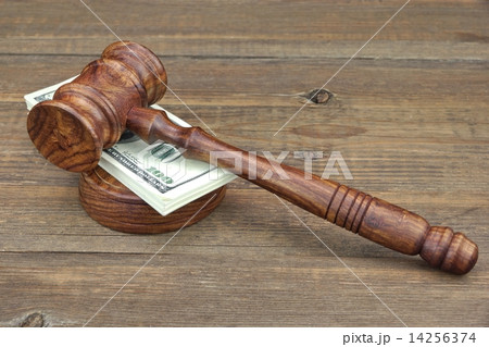 Judges Gavel and Money Wad on Grunge Wood Table 14256374