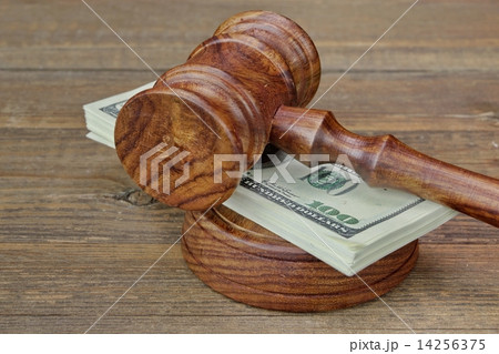 Judges Gavel and Money Wad on Grunge Wood Table Judges Gavel and Money Wad on Grunge Wood Table 14256375
