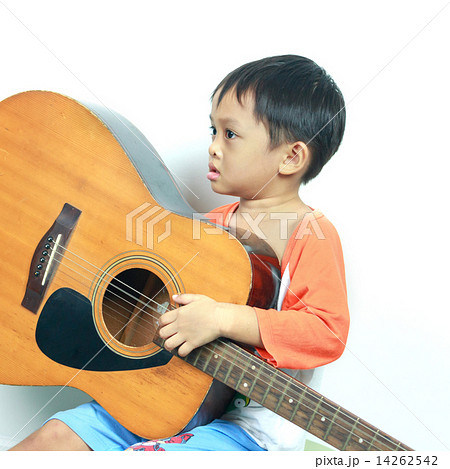 Little boy playing acoustic guitar Little boy playing acoustic guitar 14262542