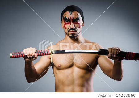 Man with sword and face paint Man with sword and face paint 14267960