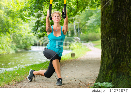 woman doing suspension sling trainer sport 14275877