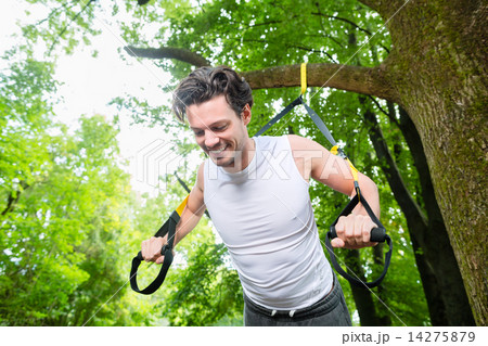 man doing suspension trainer sling sport 14275879