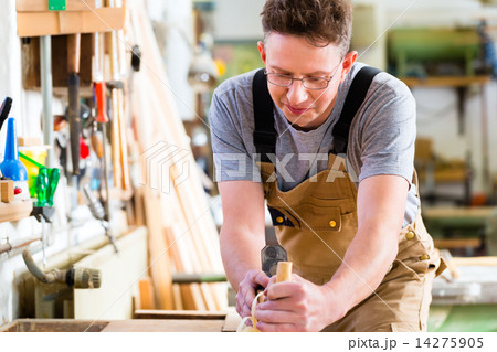 Carpenter with wood planer and workpiece in carpentry Carpenter with wood planer and workpiece in carpentry 14275905