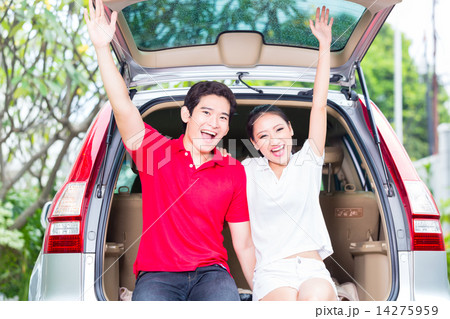 Asian couple with their new car being excited 14275959