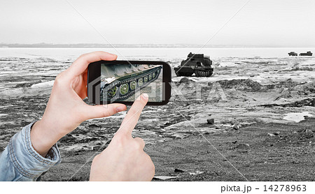 tourist taking photo tracked vehicle on ice road 14278963