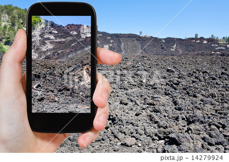 tourist taking photo of lava flow on slope of Etna tourist taking photo of lava flow on slope of Etna 14279924