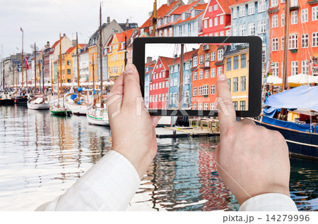 tourist taking photo of Nyhavn harbor district 14279996