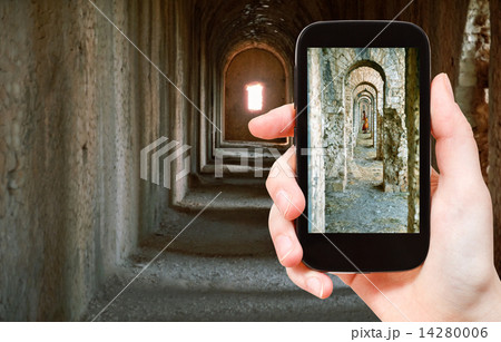tourist taking photo of ancient arcades in Temple 14280006