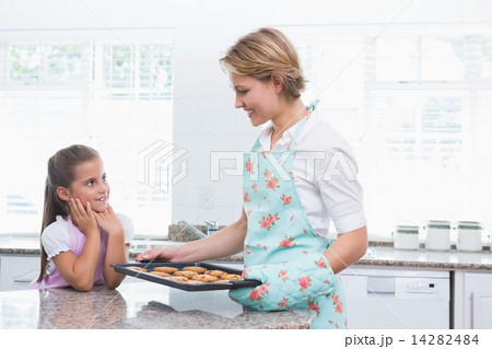 Mother and daughter with hot fresh cookies 14282484