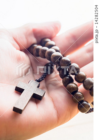 Hand holding wooden rosary beads 14282504