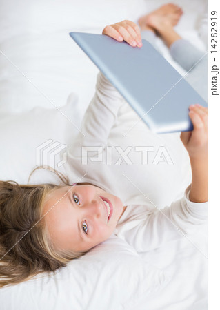 Smiling girl using tablet Smiling girl using tablet 14282919