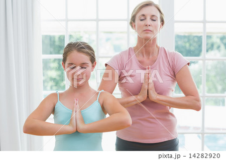 Mother and daughter doing yoga 14282920