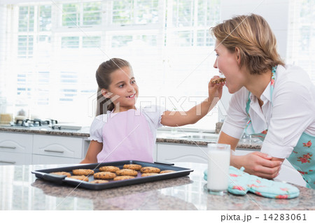 Mother and daughter with hot fresh cookies Mother and daughter with hot fresh cookies 14283061