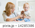 doctor woman examining heartbeat of kid boy with stethoscope 14285386