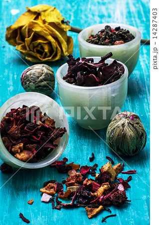 variety of dry tea leaves in jade stacks on wooden background variety of dry tea leaves in jade stacks on wooden background 14287403