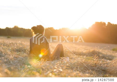 Girl sitting on meadow  14287500